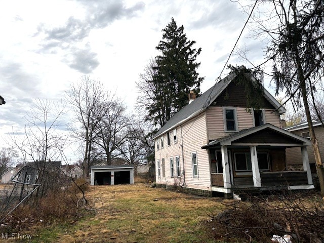 3205 W 46th St, Cleveland, OH 44102 - view of side of home with an outbuilding and a garage