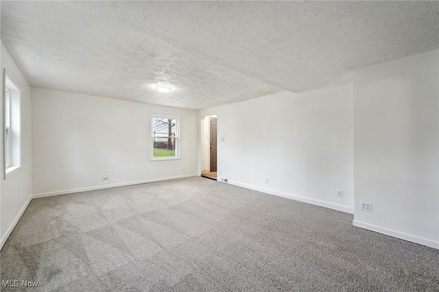 3665 Marcella Ave, Stow, OH 44224 - carpeted spare room with baseboards, arched walkways, and a textured ceiling