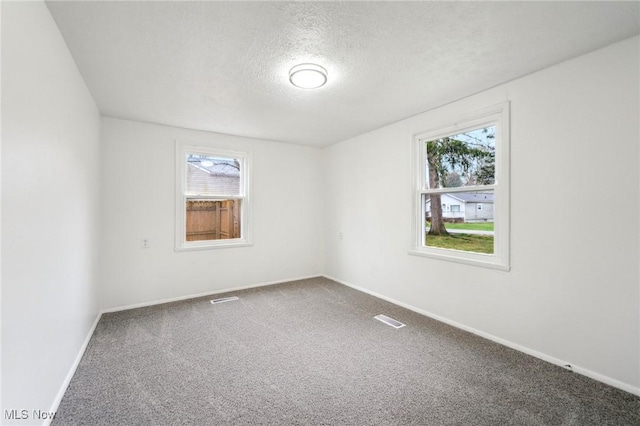 3665 Marcella Ave, Stow, OH 44224 - carpeted empty room with a textured ceiling, baseboards, and visible vents