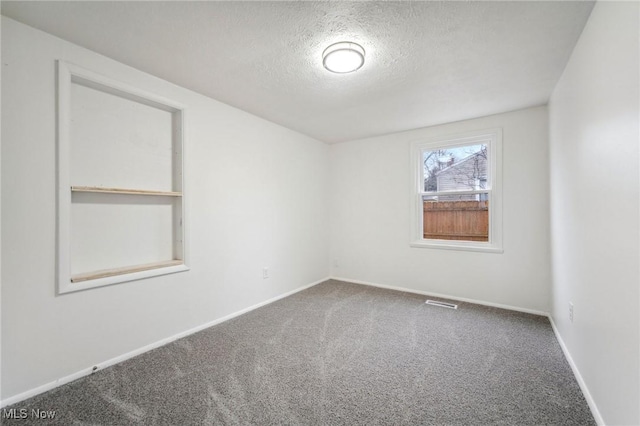 3665 Marcella Ave, Stow, OH 44224 - spare room with baseboards, carpet floors, a textured ceiling, and visible vents