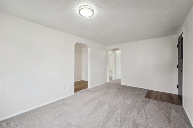 3665 Marcella Ave, Stow, OH 44224 - carpeted empty room featuring arched walkways, baseboards, and a textured ceiling