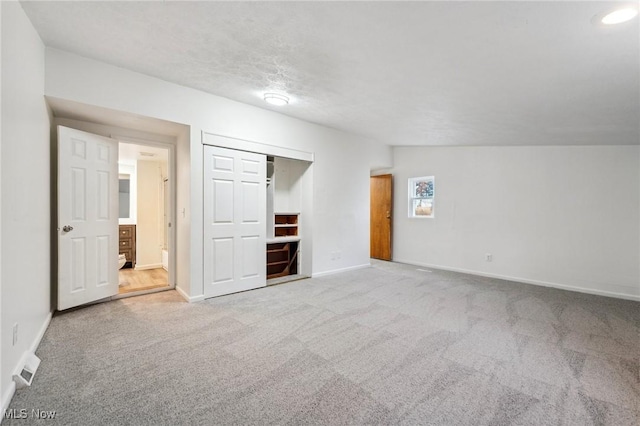 3665 Marcella Ave, Stow, OH 44224 - unfurnished bedroom with baseboards, vaulted ceiling, a closet, and carpet