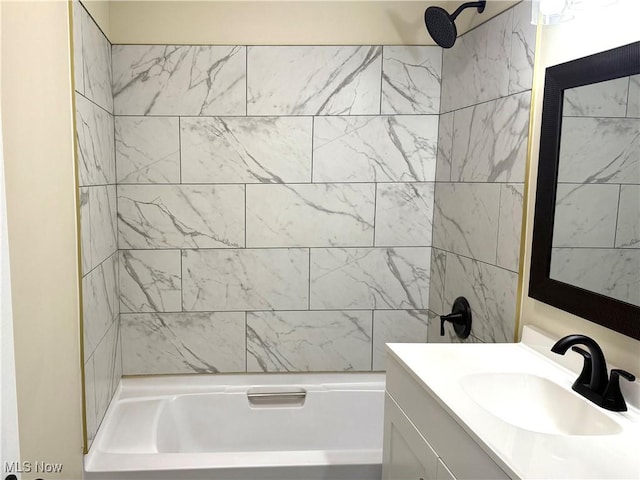 bathroom featuring  shower combination and vanity