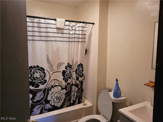 bathroom with toilet, shower / bath combo, and vanity