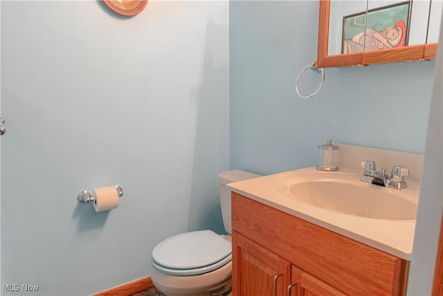 half bathroom with toilet and vanity