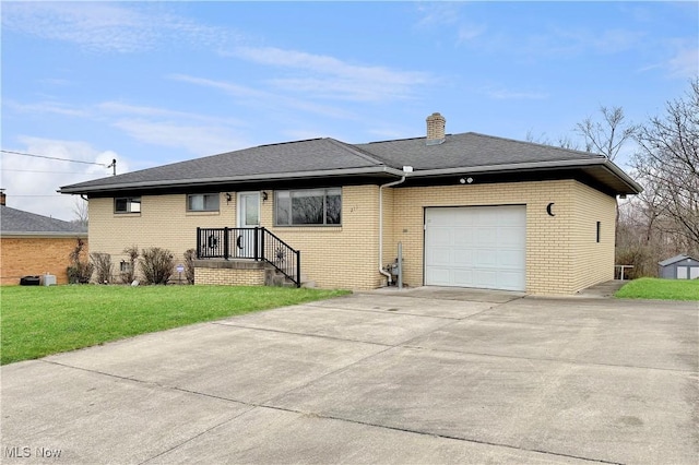 ranch-style house with concrete driveway, a chimney, an attached garage, brick siding, and a front lawn