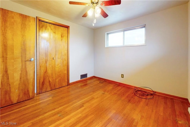 unfurnished bedroom with baseboards, visible vents, a closet, and light wood finished floors