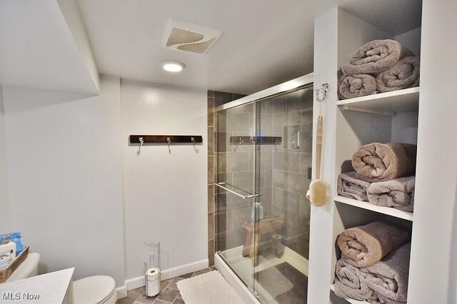 1208 Berwyn Dr SW, Sherrodsville, OH 44675 - bathroom featuring a stall shower, toilet, baseboards, and tile patterned floors