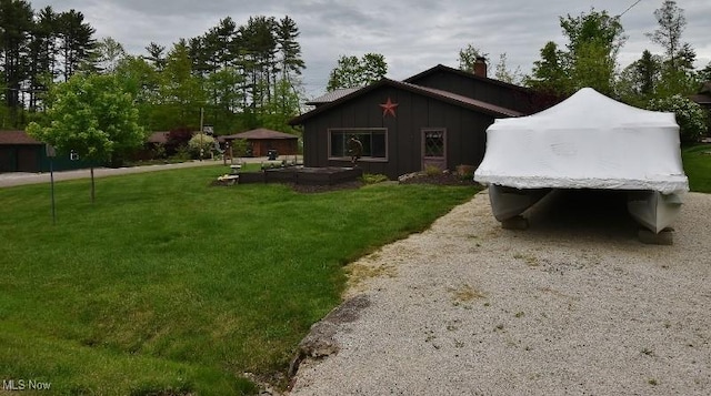 1208 Berwyn Dr SW, Sherrodsville, OH 44675 - view of side of property featuring a lawn, board and batten siding, and a chimney