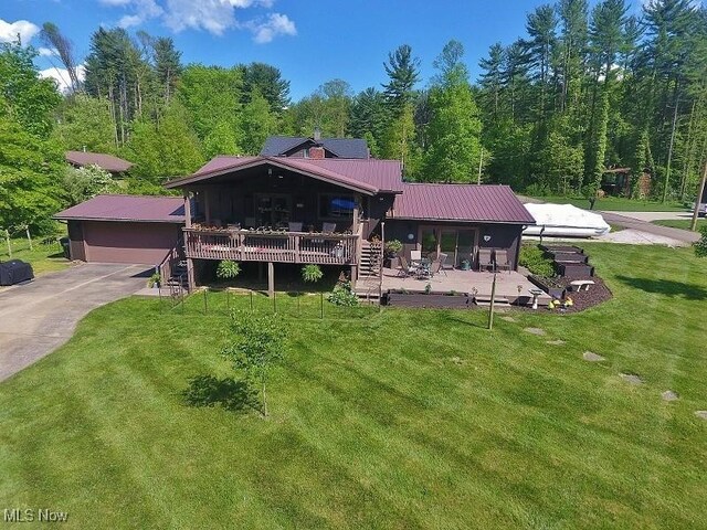 1208 Berwyn Dr SW, Sherrodsville, OH 44675 - rear view of house featuring a lawn, metal roof, stairs, a wooden deck, and a view of trees