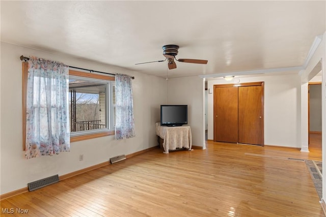 unfurnished bedroom with ceiling fan, visible vents, light wood-type flooring, and baseboards