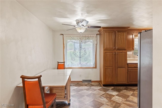 dining room with visible vents, a ceiling fan, and baseboards
