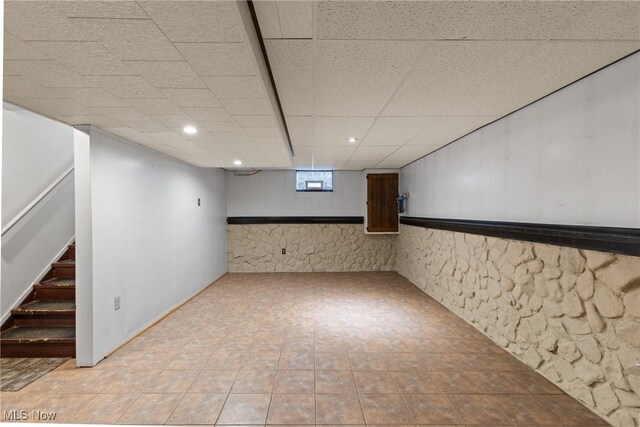 basement featuring stairway, a paneled ceiling, and recessed lighting