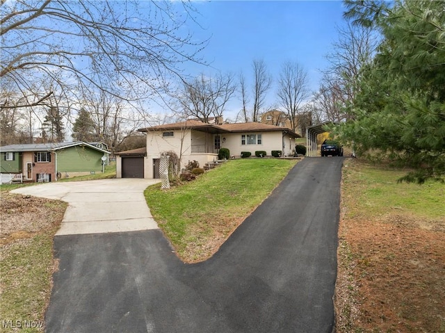 ranch-style home featuring a garage, a carport, a front lawn, and driveway