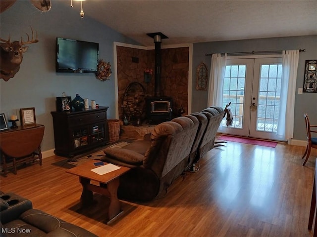 25977 E Hornsby Rd, Coolville, OH 45723 - living area with vaulted ceiling, french doors, wood finished floors, a wood stove, and baseboards