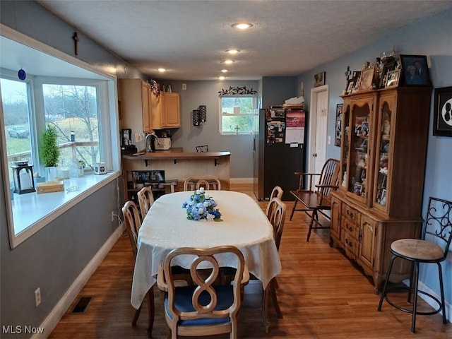 25977 E Hornsby Rd, Coolville, OH 45723 - dining room with a textured ceiling, baseboards, and wood finished floors