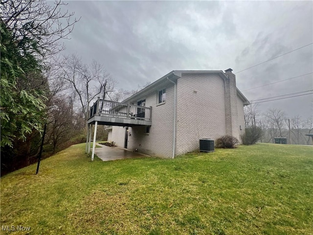 218 W Blvd, Mingo Junction, OH 43938 - view of home's exterior featuring a wooden deck, a lawn, a patio, central AC, and a chimney