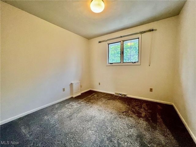 218 W Blvd, Mingo Junction, OH 43938 - empty room featuring baseboards, dark colored carpet, and visible vents