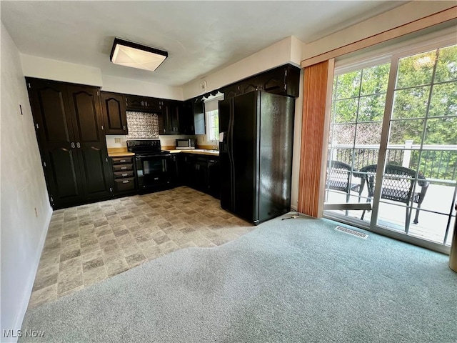 218 W Blvd, Mingo Junction, OH 43938 - kitchen featuring light countertops, a healthy amount of sunlight, black appliances, and visible vents