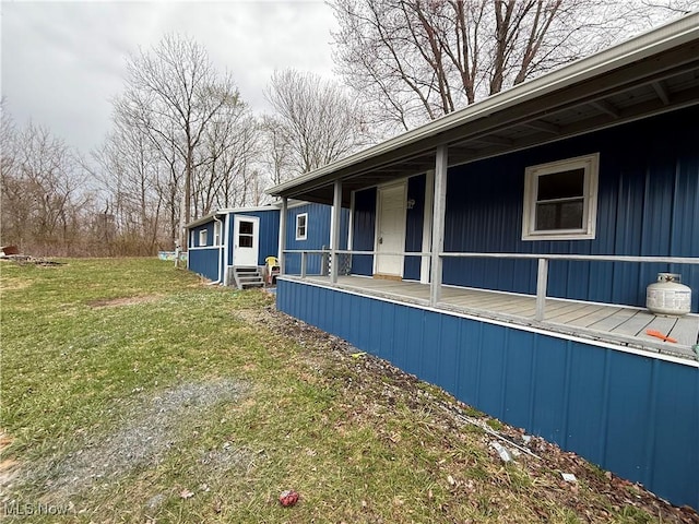 view of side of property with a lawn and entry steps