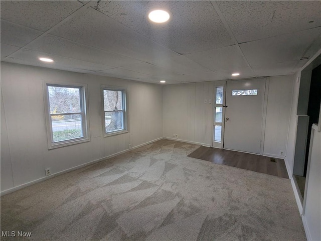 carpeted foyer featuring baseboards, recessed lighting, and a drop ceiling