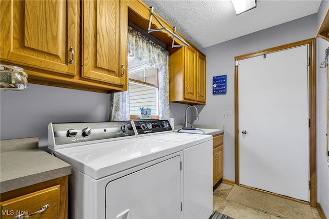 2816 Quail Run Ct, Lexington, OH 44904 - washroom with cabinet space, washing machine and dryer, and a textured ceiling