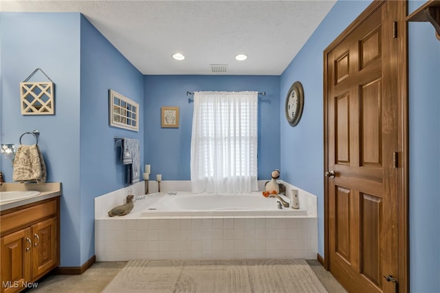 2816 Quail Run Ct, Lexington, OH 44904 - full bathroom with vanity, a garden tub, a textured ceiling, and recessed lighting