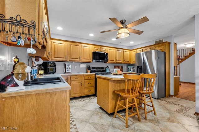 2816 Quail Run Ct, Lexington, OH 44904 - kitchen featuring appliances with stainless steel finishes, a center island, light countertops, a ceiling fan, and recessed lighting