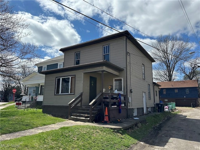 view of front of home with a porch and a front yard