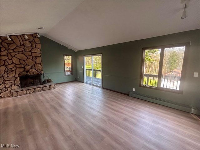 3013 Whispering Pines Dr, Canfield, OH 44406 - unfurnished living room featuring a baseboard radiator, wood finished floors, a healthy amount of sunlight, and vaulted ceiling