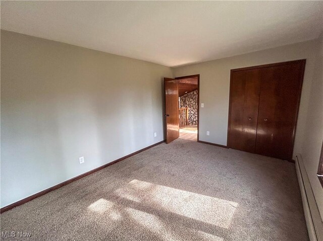 3013 Whispering Pines Dr, Canfield, OH 44406 - unfurnished bedroom featuring carpet flooring, baseboards, baseboard heating, and a closet