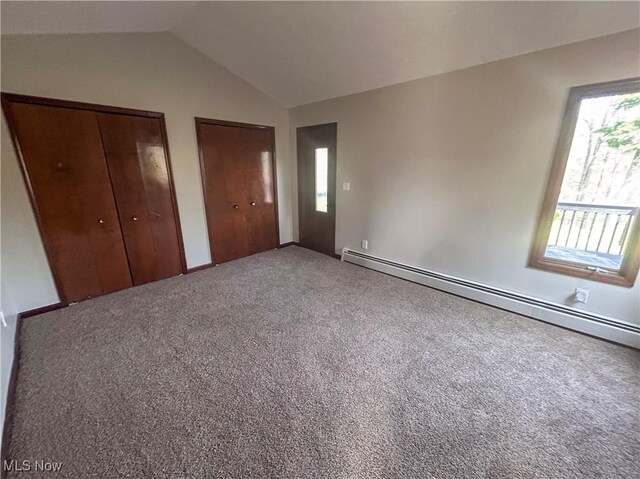 3013 Whispering Pines Dr, Canfield, OH 44406 - unfurnished bedroom featuring carpet flooring, a baseboard heating unit, two closets, and lofted ceiling