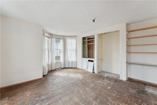 34 N Park St, Oberlin, OH 44074 - spare room with a textured ceiling, baseboards, and fire sprinkler in ceiling