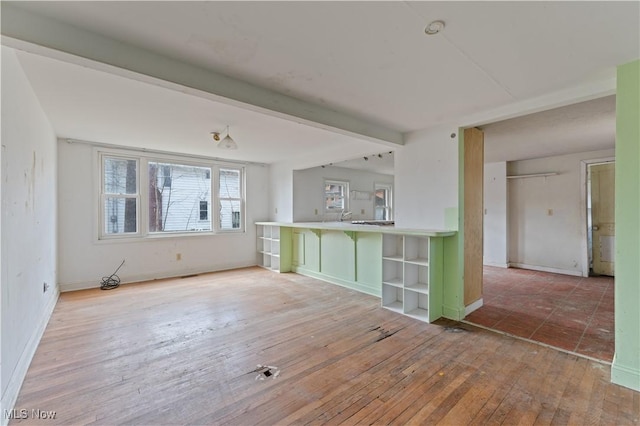 34 N Park St, Oberlin, OH 44074 - kitchen featuring open shelves, hardwood / wood-style floors, baseboards, beam ceiling, and light countertops