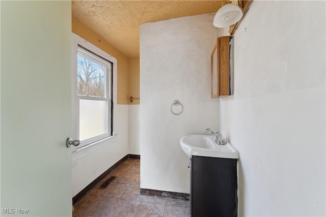 34 N Park St, Oberlin, OH 44074 - bathroom with vanity, baseboards, and a textured ceiling
