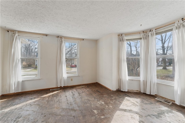 34 N Park St, Oberlin, OH 44074 - spare room featuring healthy amount of natural light, a textured ceiling, and baseboards