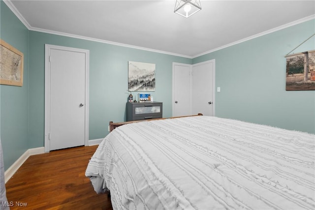 bedroom featuring crown molding, baseboards, and wood finished floors