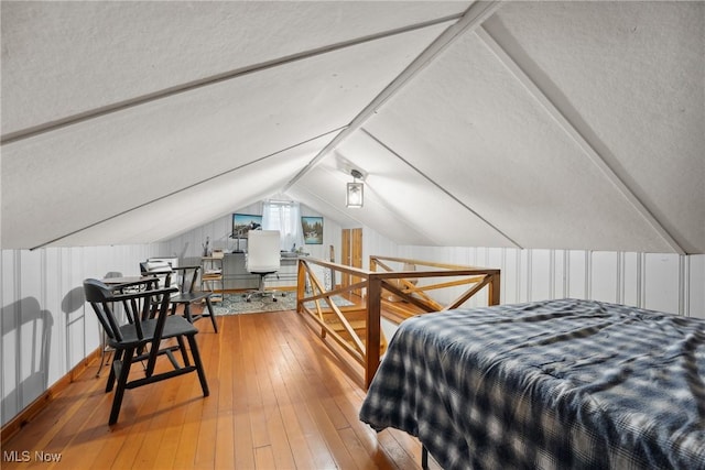 bedroom featuring vaulted ceiling and wood-type flooring