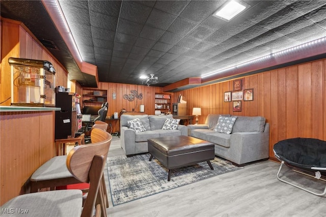 living room with wooden walls and wood finished floors