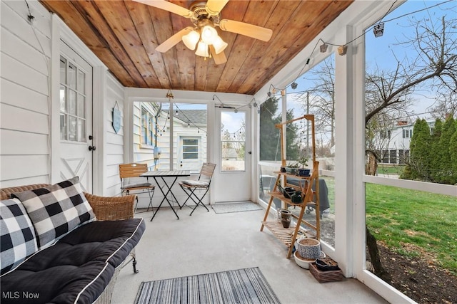 sunroom with wooden ceiling, ceiling fan, and carpet flooring