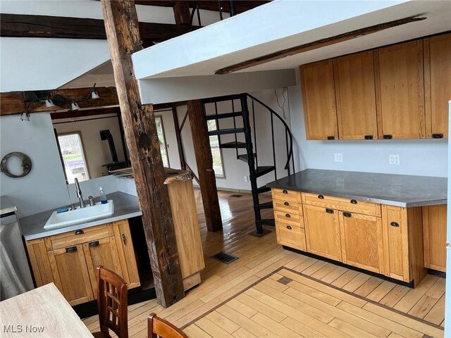 6232 Weaver Rd, Conneaut, OH 44030 - kitchen with a sink, light wood-style floors, brown cabinets, and dishwasher