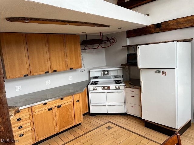 6232 Weaver Rd, Conneaut, OH 44030 - kitchen with white appliances, dark countertops, light wood-style floors, brown cabinetry, and ventilation hood