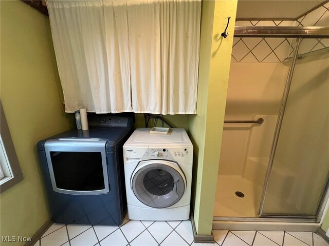 6232 Weaver Rd, Conneaut, OH 44030 - laundry room featuring laundry area, light tile patterned flooring, and separate washer and dryer