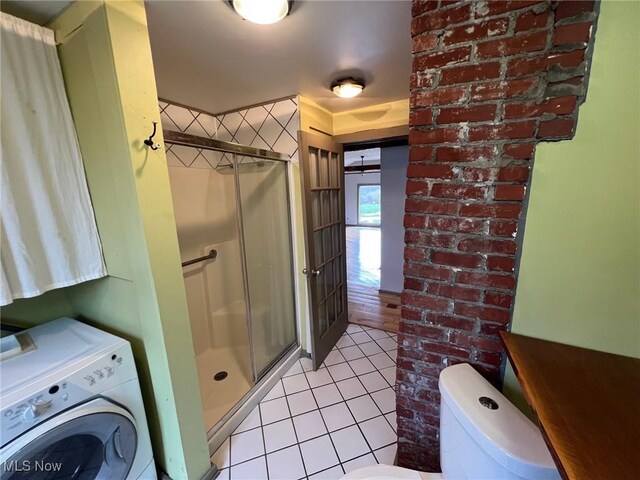 6232 Weaver Rd, Conneaut, OH 44030 - full bathroom featuring toilet, washer / dryer, a stall shower, and tile patterned floors