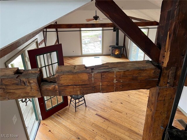 6232 Weaver Rd, Conneaut, OH 44030 - interior space with visible vents, ceiling fan, wood finished floors, lofted ceiling, and a wood stove