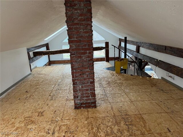 6232 Weaver Rd, Conneaut, OH 44030 - bonus room featuring baseboards, a textured ceiling, and vaulted ceiling
