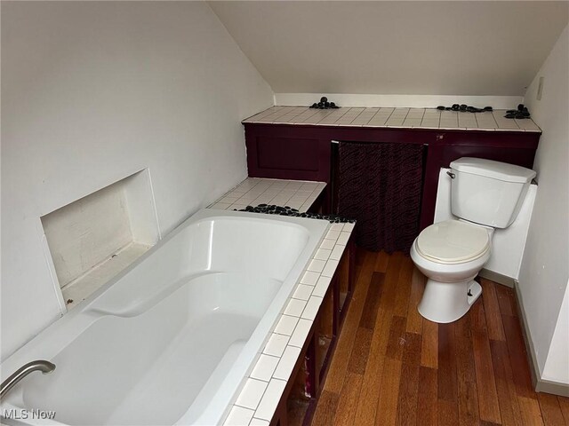6232 Weaver Rd, Conneaut, OH 44030 - bathroom featuring toilet, a garden tub, and wood finished floors