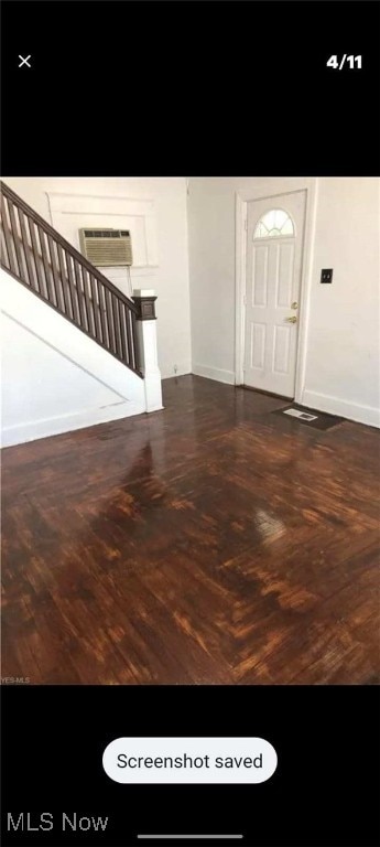 entrance foyer featuring a wall mounted AC, baseboards, and stairway