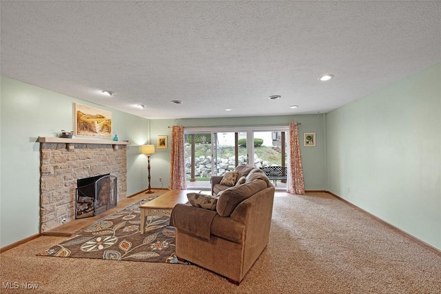 4613 Compass Rose Unit 10, Vermilion, OH 44089 - carpeted living area featuring a stone fireplace, a textured ceiling, baseboards, and recessed lighting