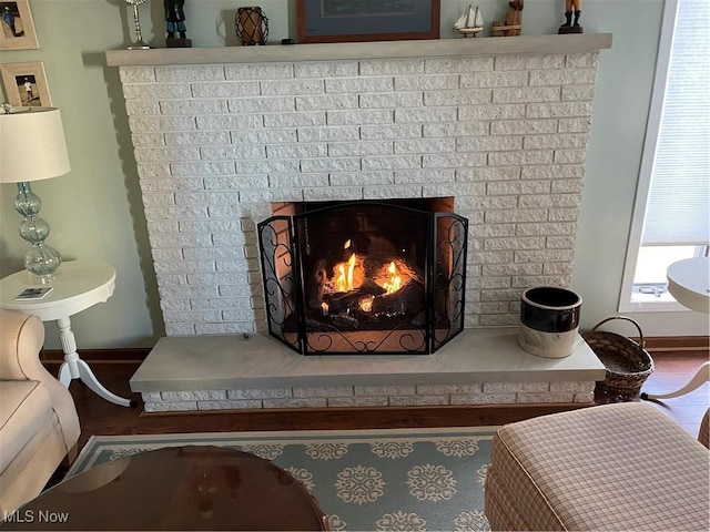 4613 Compass Rose Unit 10, Vermilion, OH 44089 - detailed view of a brick fireplace, wood finished floors, and baseboards